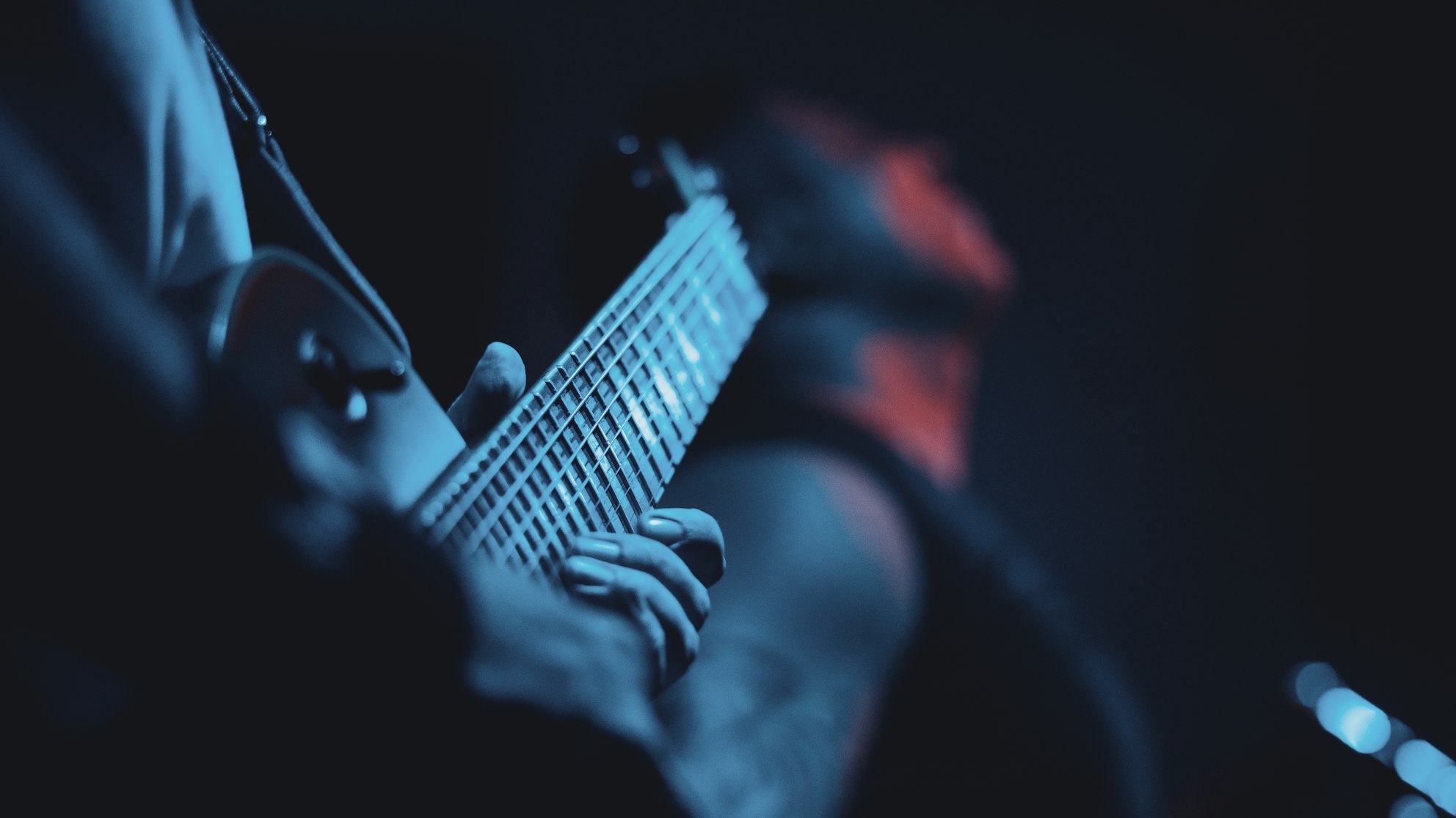 Musician playing electric guitar on stage